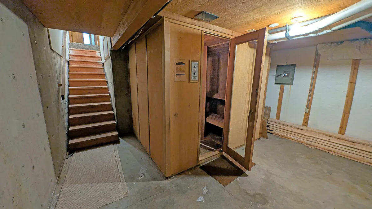 A serene sauna room with wooden benches and natural wood-paneled walls, evoking tranquility and relaxation. The space invites quiet self-care or social unwinding after a day of adventure.